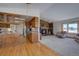 Inviting living room next to kitchen features a stone fireplace, and plush seating at 11810 Mesa View Rd, Larkspur, CO 80118