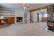 Spacious living room features built-in shelving, fireplace, wood beams, and neutral carpeting at 11810 Mesa View Rd, Larkspur, CO 80118