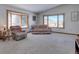 Bright living room with large windows, plush seating, and serene outdoor views at 11810 Mesa View Rd, Larkspur, CO 80118