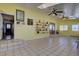 Bright living room featuring tile flooring, skylights, and shelving for decor at 11810 Mesa View Rd, Larkspur, CO 80118