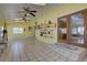 Bright living room boasts tile flooring, views, and wall shelving at 11810 Mesa View Rd, Larkspur, CO 80118