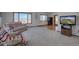 Spacious living room with large windows, plush seating, and neutral decor at 11810 Mesa View Rd, Larkspur, CO 80118