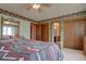 Traditional bedroom with adjacent bathroom and closet access at 11810 Mesa View Rd, Larkspur, CO 80118
