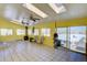 Bright sunroom features tile flooring, vaulted ceiling, and large windows with exterior access at 11810 Mesa View Rd, Larkspur, CO 80118