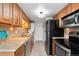 Updated kitchen features wood cabinets, stainless steel appliances, and ample countertop space at 7999 Chase Cir # 31, Arvada, CO 80003