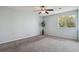 This empty bedroom features a large window with natural light and carpet floors at 3051 S Ursula Cir # 302, Aurora, CO 80014