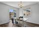 Dining area featuring a chandelier, window, and sliding doors to the balcony at 3051 S Ursula Cir # 302, Aurora, CO 80014