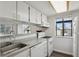 A kitchen featuring white appliances and cabinets at 3051 S Ursula Cir # 302, Aurora, CO 80014