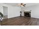 A living room with hardwood floors and fireplace with access to another room at 3051 S Ursula Cir # 302, Aurora, CO 80014