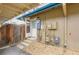 Back entrance features a storm door, utility access, concrete steps, and a low-maintenance stone ground cover at 8759 E Roundtree Ave, Greenwood Village, CO 80111