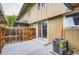 Private back patio with gray painted deck, wooden fence, and sliding glass door access into the home at 8759 E Roundtree Ave, Greenwood Village, CO 80111