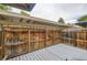 Enclosed back patio with stained fence and light gray painted deck provides a private outdoor living space at 8759 E Roundtree Ave, Greenwood Village, CO 80111