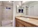 A renovated bathroom featuring a tub, shower, toilet, and large vanity at 8759 E Roundtree Ave, Greenwood Village, CO 80111