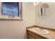 Cozy bathroom with a classic vanity, neutral color palette, and natural light at 8759 E Roundtree Ave, Greenwood Village, CO 80111