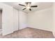 A bright bedroom with ceiling fan, neutral walls, carpeting and closet doors at 8759 E Roundtree Ave, Greenwood Village, CO 80111