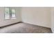 A bright bedroom with neutral walls, carpeting and view to the outdoors through double windows at 8759 E Roundtree Ave, Greenwood Village, CO 80111