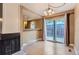 Dining area with sliding glass door to patio, adjacent to kitchen, with wood flooring at 8759 E Roundtree Ave, Greenwood Village, CO 80111