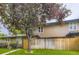 Exterior view of the townhouse with vibrant green lawn and mature trees that provide ample shade at 8759 E Roundtree Ave, Greenwood Village, CO 80111