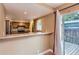 Kitchen features stainless steel appliances, granite countertops, and sliding door to deck at 8759 E Roundtree Ave, Greenwood Village, CO 80111