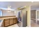 Modern kitchen showcasing stainless steel refrigerator, wood cabinets, and ample counter space at 8759 E Roundtree Ave, Greenwood Village, CO 80111