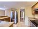 Well-equipped kitchen with stainless steel appliances, wood cabinets, and tile flooring at 8759 E Roundtree Ave, Greenwood Village, CO 80111