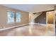 Inviting living room featuring wood floors, staircase, and large windows for ample natural light at 8759 E Roundtree Ave, Greenwood Village, CO 80111