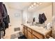 Bathroom with double sinks, granite countertops, a soaking tub, and tile floors at 552 S Mobile Pl, Aurora, CO 80017