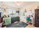 Cozy bedroom with natural light, a ceiling fan, and a dedicated desk area at 552 S Mobile Pl, Aurora, CO 80017