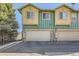Close exterior shot of a townhome showing garages and partial view at 552 S Mobile Pl, Aurora, CO 80017