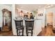 Kitchen with a breakfast bar, wood cabinets, granite countertops, and stainless steel appliances at 552 S Mobile Pl, Aurora, CO 80017