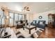 Cozy living room showcasing hardwood floors, plush seating, and large windows for ample natural light at 552 S Mobile Pl, Aurora, CO 80017