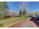 Lush backyard featuring a green lawn and mature trees providing privacy and shade at 1413 Ben Nevis Ave, Broomfield, CO 80020