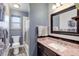 Bathroom boasts granite counters, modern fixtures, and shower with glass door at 1413 Ben Nevis Ave, Broomfield, CO 80020
