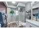 Bathroom features a glass enclosed shower, modern vanity, and washer and dryer units at 1413 Ben Nevis Ave, Broomfield, CO 80020