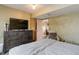 Bedroom is furnished with a large bed, dresser, and view to an adjacent room at 1413 Ben Nevis Ave, Broomfield, CO 80020
