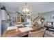 Dining room view to kitchen with stainless steel appliances and breakfast bar at 1413 Ben Nevis Ave, Broomfield, CO 80020
