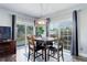 Bright dining room featuring a modern light fixture, wood table set for four, and sliding glass doors at 1413 Ben Nevis Ave, Broomfield, CO 80020