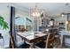 Dining area featuring modern lighting fixture and an open view into the kitchen at 1413 Ben Nevis Ave, Broomfield, CO 80020