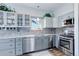 Modern kitchen with stainless steel appliances, tile backsplash, granite countertops, and ample cabinetry at 1413 Ben Nevis Ave, Broomfield, CO 80020