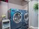 Bright laundry room equipped with a modern washer and dryer units at 1413 Ben Nevis Ave, Broomfield, CO 80020