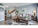 Comfortable living room with a couch, decorative artwork, staircase, and hardwood floors at 1413 Ben Nevis Ave, Broomfield, CO 80020