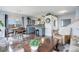Open-concept living space with hardwood floors, modern lighting, and a view of the kitchen and entry way at 1413 Ben Nevis Ave, Broomfield, CO 80020