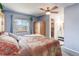 Bright bedroom featuring a ceiling fan, large closet, and an ensuite bathroom at 1413 Ben Nevis Ave, Broomfield, CO 80020