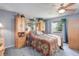 Comfortable main bedroom with a ceiling fan, built in cabinets, and a window at 1413 Ben Nevis Ave, Broomfield, CO 80020