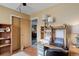 Office space features a wooden desk, shelving, and view to an adjacent bedroom at 1413 Ben Nevis Ave, Broomfield, CO 80020