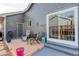 Outdoor patio area with seating, sliding glass doors and exterior access at 1413 Ben Nevis Ave, Broomfield, CO 80020