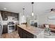 Spacious kitchen with island, stainless steel appliances and view to living room at 2510 Concord Cir, Lafayette, CO 80026