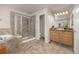 Bathroom features a large tub, glass enclosed shower, and vanity at 14246 Piney River Rd, Broomfield, CO 80023