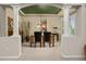 Elegant dining room featuring white pillars, neutral walls, and a view into the kitchen at 14246 Piney River Rd, Broomfield, CO 80023