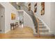 Grand foyer with hardwood floors, a curved staircase, and a view into the living room at 14246 Piney River Rd, Broomfield, CO 80023